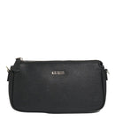 A black textured leather GUESS crossbody bag with a silver-tone logo on the front, set against a light gray background.
