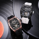 Two Richard Mille wristwatches displayed on black vinyl records. One watch has a black case and black strap, while the other has a rose gold-toned case and a white strap.