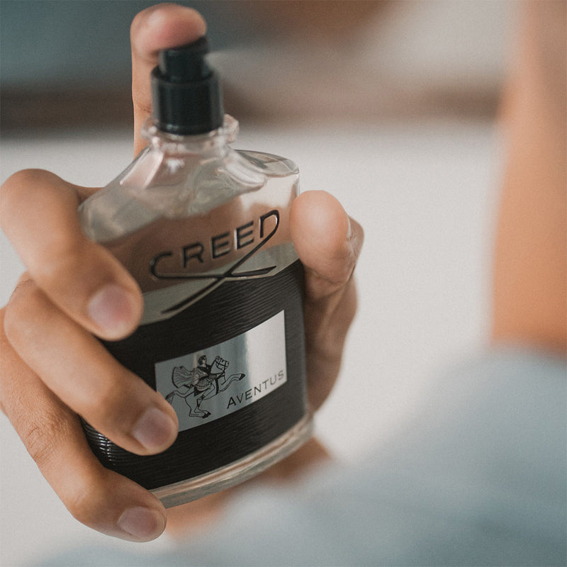 Sleek and sophisticated Creed Aventus 100ml EDP bottle featuring a silver atomizer and embossed logo. Shop now at xpressions.ae.