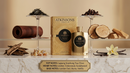 Atkinson's London 1947 Eau de Parfum bottle and box displayed on a marble surface with fragrance ingredients arranged around it, including tea leaves, cloves, leather, cedarwood, sandalwood, vanilla beans, and a vanilla flower. A text plaque at the bottom lists the top, heart, and base notes.