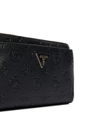 Close-up of a black Guess wallet featuring an embossed monogram pattern and the signature triangular metal logo plaque on the front flap.