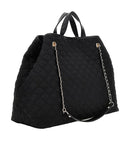 A black quilted nylon tote bag with dual top handles, a detachable black shoulder strap, and a silver-tone chain link accent, shown on a light gray background.