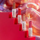 Lipstick products with 'Glossy Elaze' branding on a vibrant red and orange background.