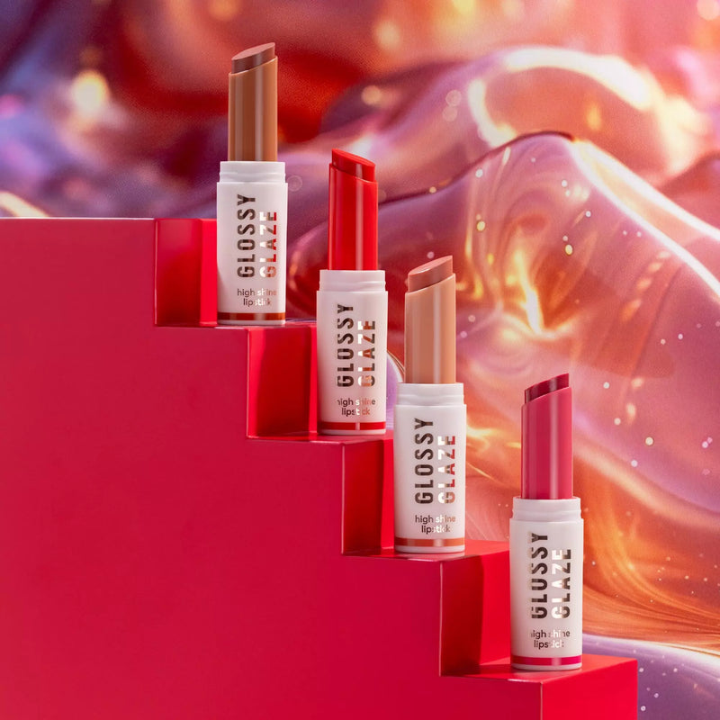 Lipstick products with 'Glossy Elaze' branding on a vibrant red and orange background.