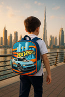 Child wearing a Hot Wheels backpack with a cityscape and skyscrapers in the background
