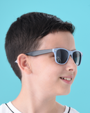 Child wearing sunglasses with a blue background