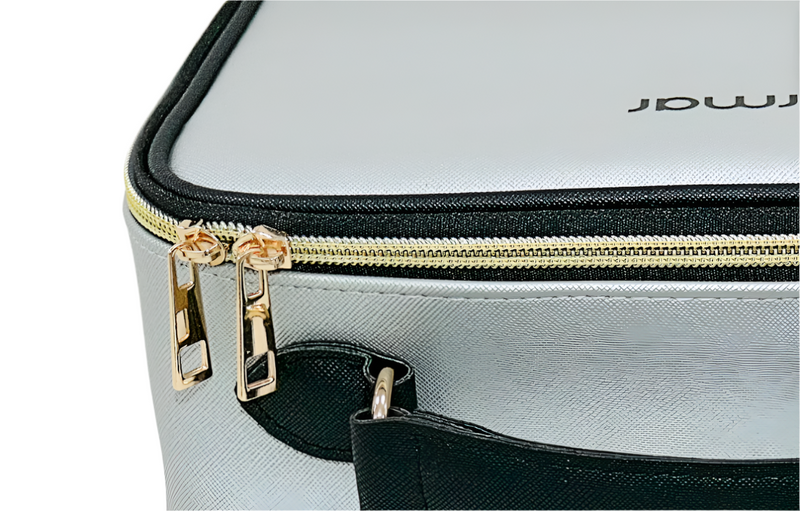 Gray suitcase with gold zipper and black accents on a light gray background